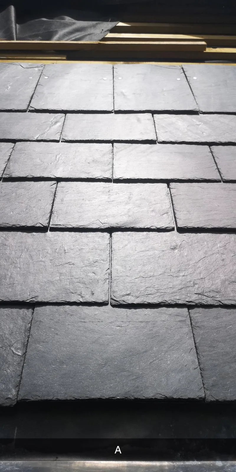 a close up of a black slate tile floor